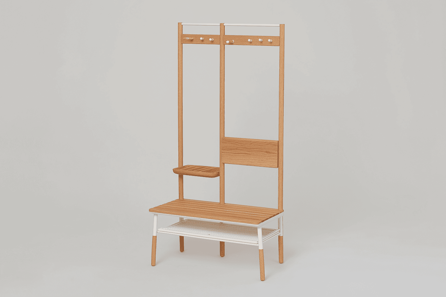 A wooden hall tree with a bench, coat hooks and an upper shelf against a white wall